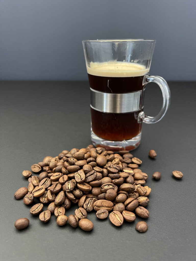 Freshly brewed coffee and whole coffee beans